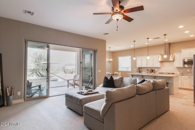 carpeted living room featuring ceiling fan