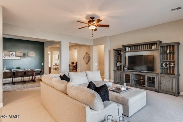 living room featuring ceiling fan and carpet floors