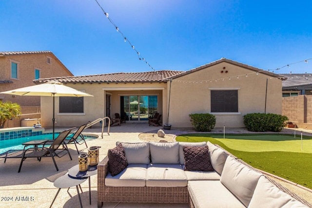 back of property featuring a patio area and an outdoor hangout area