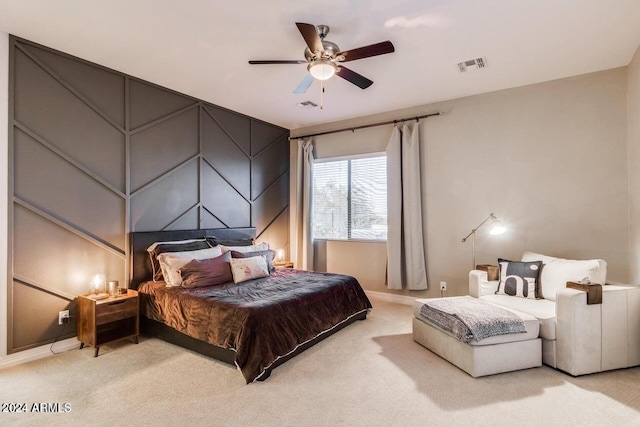 bedroom featuring light carpet and ceiling fan