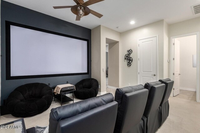 carpeted home theater with ceiling fan