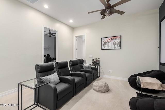 carpeted home theater room with ceiling fan