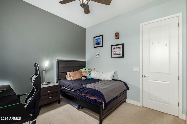 carpeted bedroom with vaulted ceiling and ceiling fan