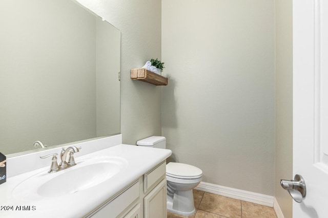 bathroom featuring vanity, toilet, and tile patterned flooring