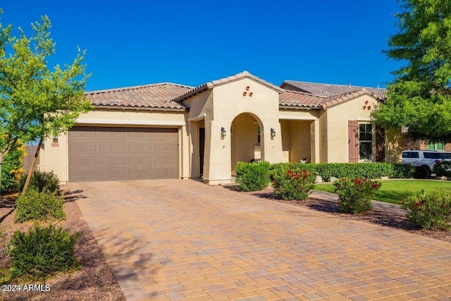 mediterranean / spanish house featuring a garage