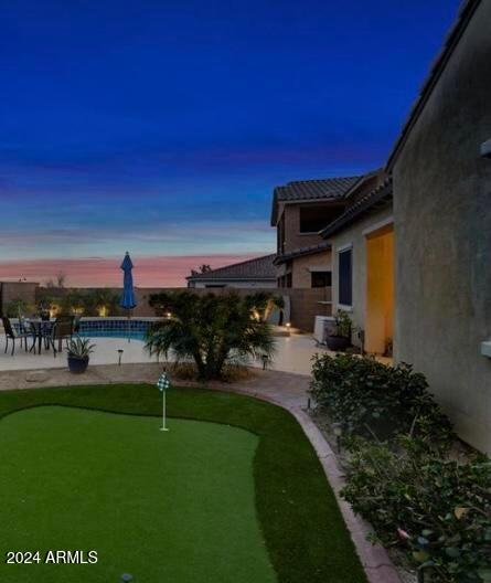 yard at dusk with a patio