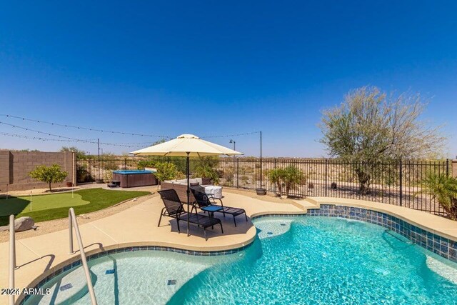 view of pool featuring a patio and a hot tub