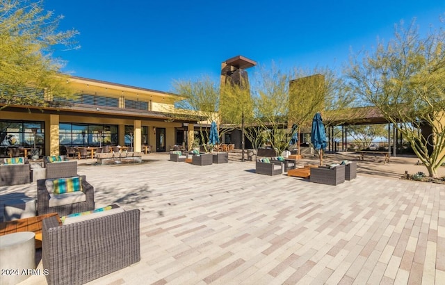 surrounding community featuring an outdoor hangout area and a patio