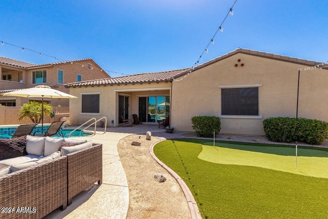 back of property featuring a patio area and outdoor lounge area