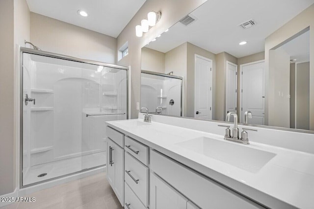 full bathroom with a sink, visible vents, and a shower stall