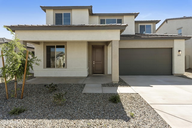 prairie-style house featuring driveway and stucco siding