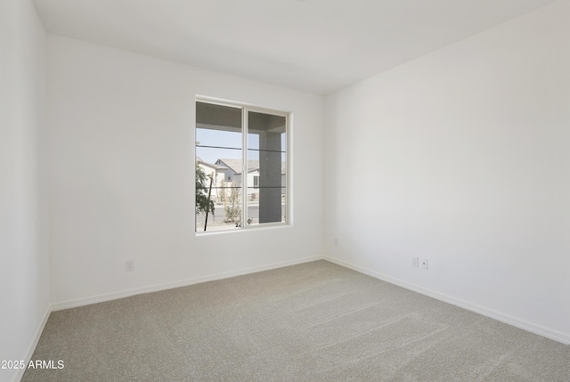 empty room with carpet flooring and baseboards