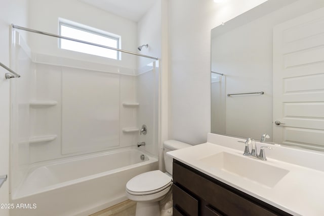 bathroom featuring toilet, washtub / shower combination, wood finished floors, and vanity