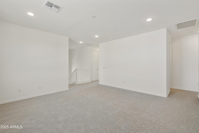 unfurnished room featuring recessed lighting, visible vents, light carpet, and baseboards