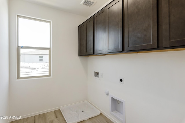 laundry room with hookup for a gas dryer, hookup for an electric dryer, washer hookup, visible vents, and cabinet space