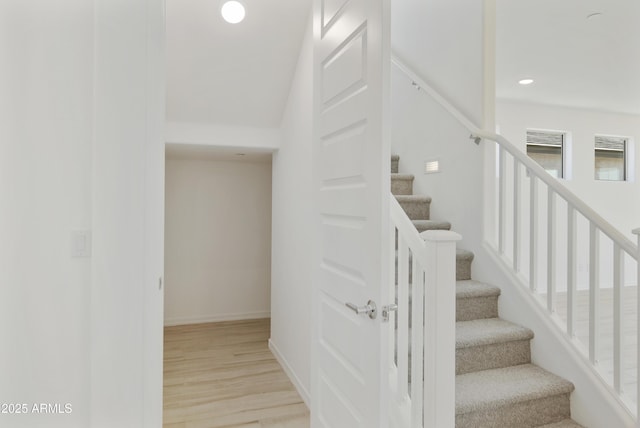 staircase with recessed lighting, baseboards, and wood finished floors