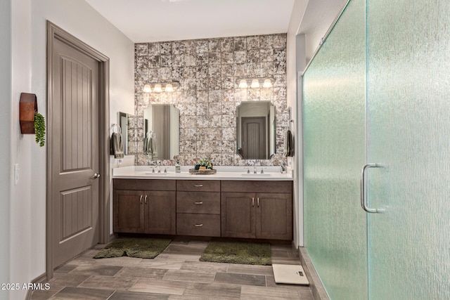 bathroom with vanity and a shower with door
