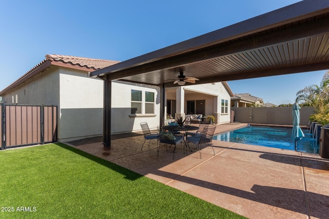 view of pool with ceiling fan, a lawn, and a patio area