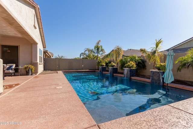 view of pool featuring pool water feature and a patio