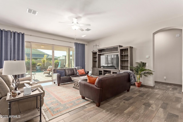 living room with ceiling fan and dark hardwood / wood-style floors