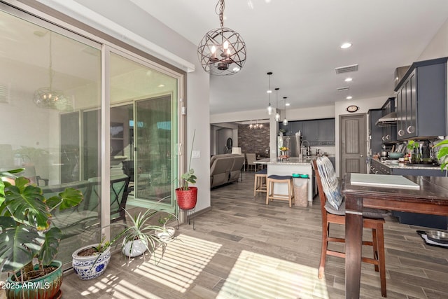dining room with an inviting chandelier and light hardwood / wood-style floors