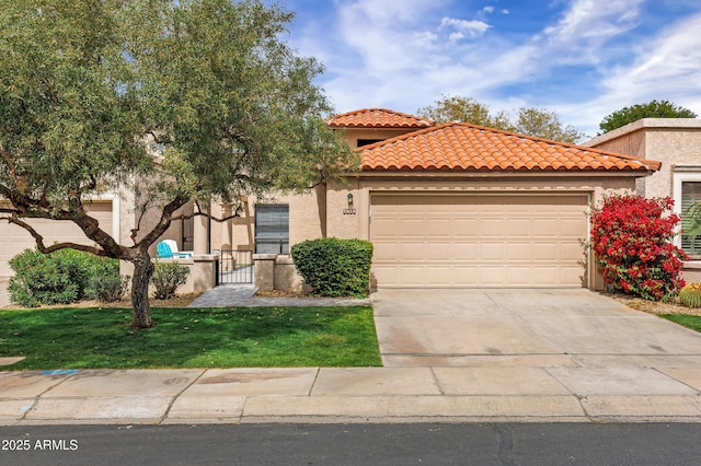 mediterranean / spanish-style house with stucco siding, concrete driveway, an attached garage, a tiled roof, and a front lawn