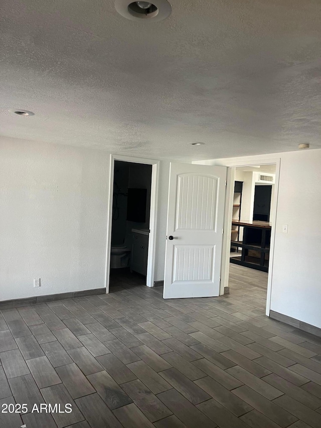 spare room with a textured ceiling