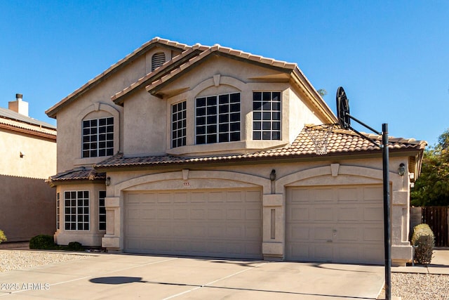 mediterranean / spanish house with a garage