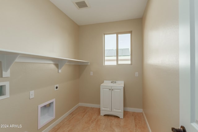 laundry area featuring hookup for an electric dryer, cabinets, and sink