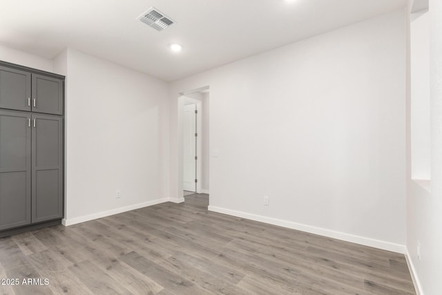 unfurnished room with light hardwood / wood-style floors