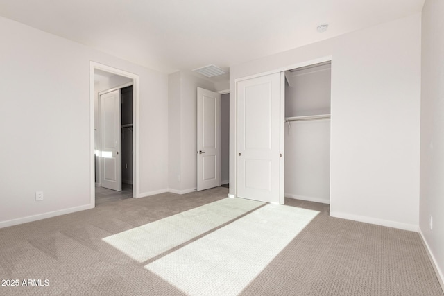 unfurnished bedroom featuring a closet and light colored carpet