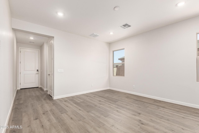 unfurnished room with light hardwood / wood-style floors