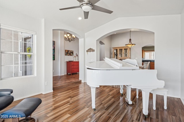 living area featuring baseboards, lofted ceiling, ceiling fan, wood finished floors, and recessed lighting