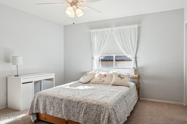 carpeted bedroom featuring a ceiling fan and baseboards