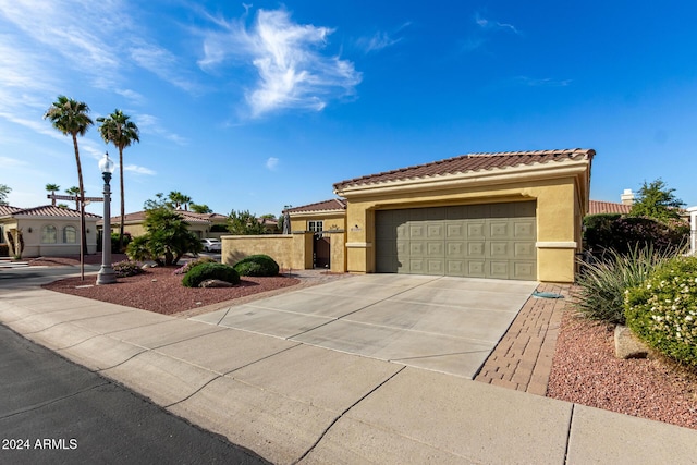 mediterranean / spanish-style home with a garage