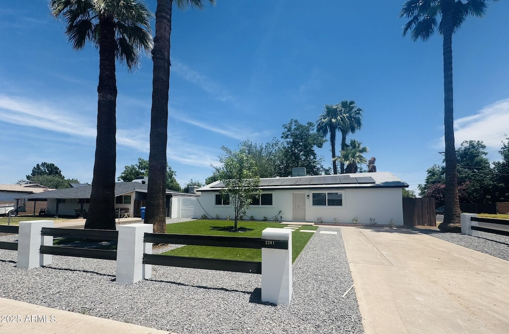 2201 N 29th Pl, Phoenix, AZ 85008 - ranch-style house featuring roof mounted solar panels and stucco siding
