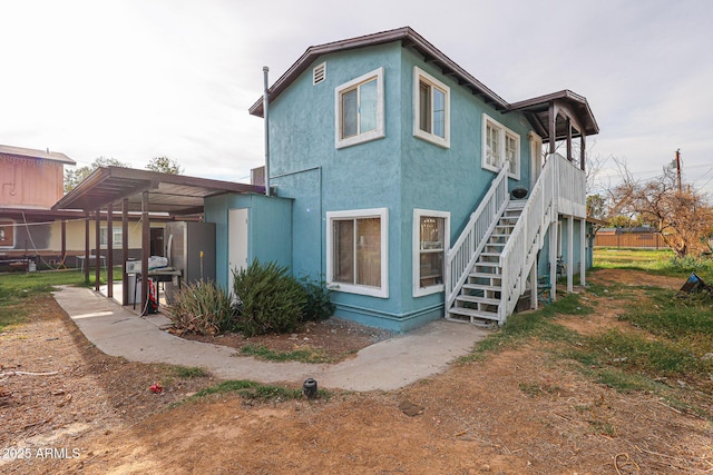 5239 W Maryland Ave, Glendale, AZ 85301 - rear view of property featuring stairs and stucco siding