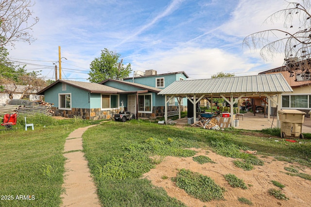 5239 W Maryland Ave, Glendale, AZ 85301 - view of front of home with stone siding, a gazebo, a patio, stucco siding, and a front lawn