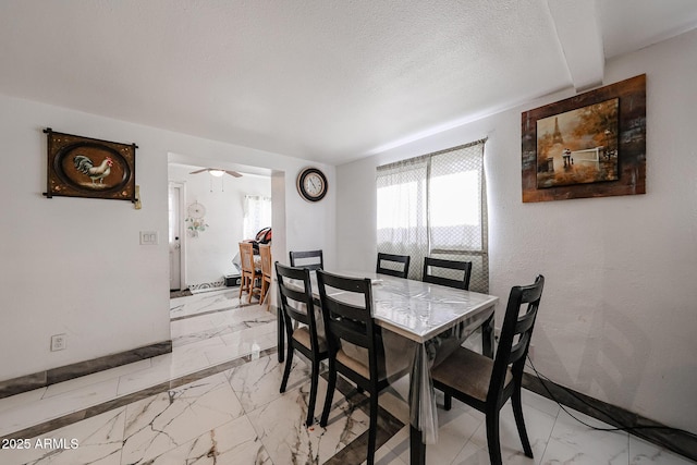 5239 W Maryland Ave, Glendale, AZ 85301 - dining area featuring light marble finish floors, ceiling fan, and a textured ceiling