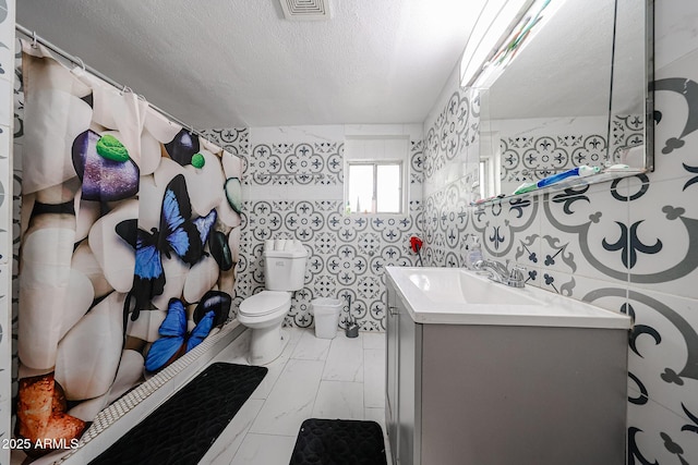 5239 W Maryland Ave, Glendale, AZ 85301 - bathroom featuring toilet, marble look tiles, vanity, and a textured ceiling
