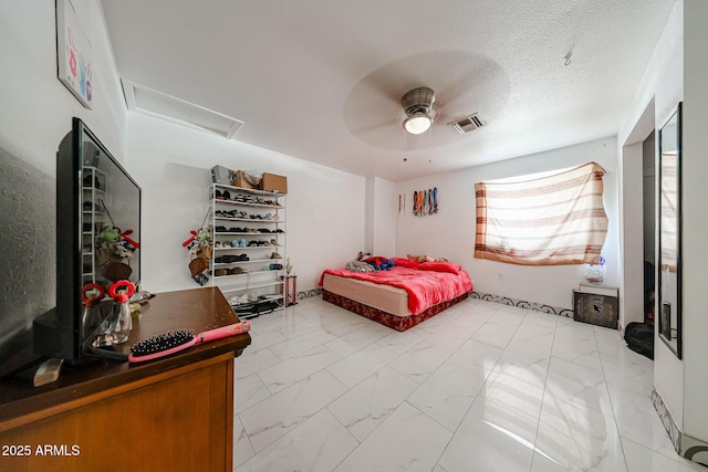 5239 W Maryland Ave, Glendale, AZ 85301 - bedroom featuring attic access, light marble finish floors, ceiling fan, and a textured ceiling