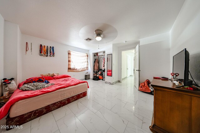 5239 W Maryland Ave, Glendale, AZ 85301 - bedroom featuring light marble finish floors, a ceiling fan, and a closet