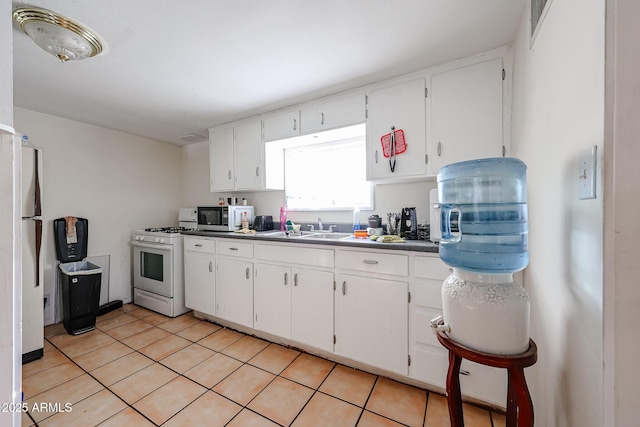 5239 W Maryland Ave, Glendale, AZ 85301 - kitchen featuring white appliances, a sink, white cabinetry, and light tile patterned floors