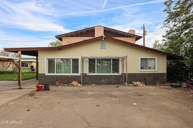 5239 W Maryland Ave, Glendale, AZ 85301 - rear view of house with stucco siding and a chimney