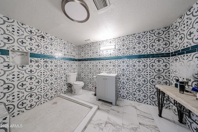 5239 W Maryland Ave, Glendale, AZ 85301 - bathroom with toilet, a textured ceiling, and marble finish floors