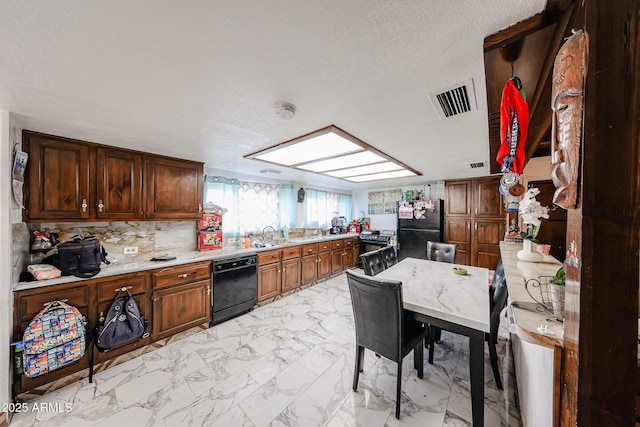 5239 W Maryland Ave, Glendale, AZ 85301 - kitchen with black appliances, light countertops, light marble finish flooring, a textured ceiling, and tasteful backsplash