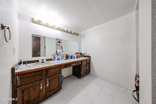 5239 W Maryland Ave, Glendale, AZ 85301 - bathroom featuring marble look tile flooring, double vanity, and a textured ceiling