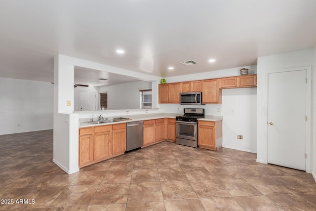 12425 W Willow Ave, El Mirage, AZ 85335 - kitchen featuring stainless steel appliances, a sink, light countertops, recessed lighting, and baseboards