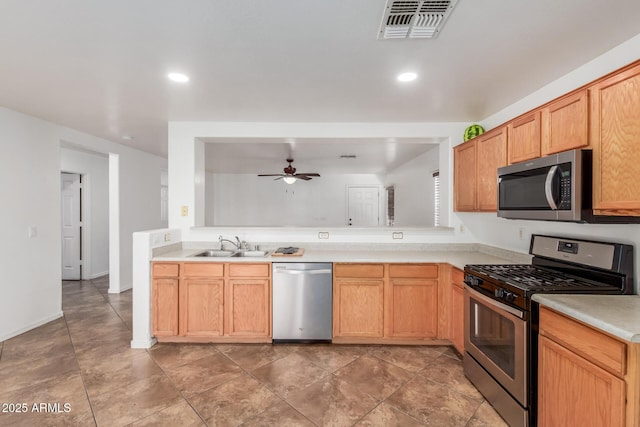 12425 W Willow Ave, El Mirage, AZ 85335 - kitchen with appliances with stainless steel finishes, a sink, light countertops, ceiling fan, and recessed lighting