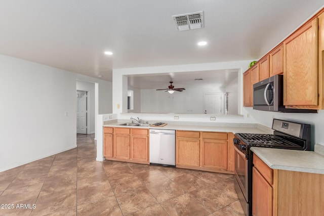12425 W Willow Ave, El Mirage, AZ 85335 - kitchen with appliances with stainless steel finishes, a sink, a ceiling fan, light countertops, and recessed lighting